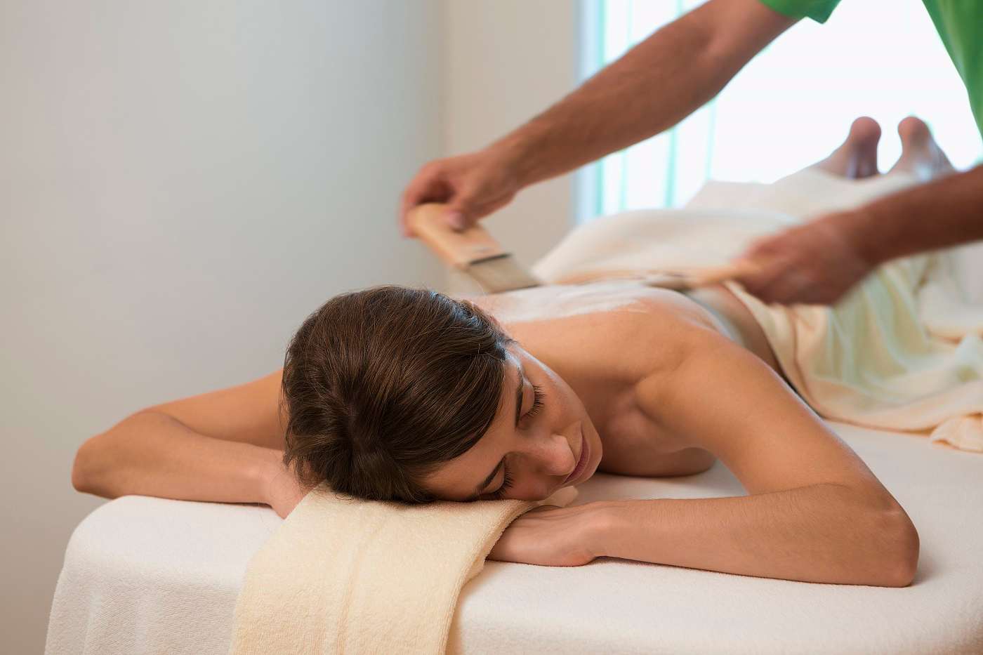 Junge Frau auf Liege erhält eine Spa-Behandlung im Wellnesshotel Ritzenhof