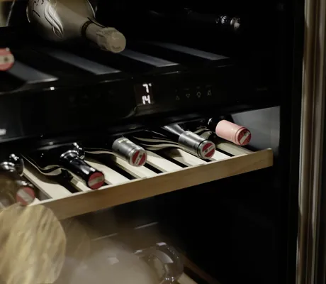 Mehrere Weinflaschen in einem Schrank in den Hygna Chalets