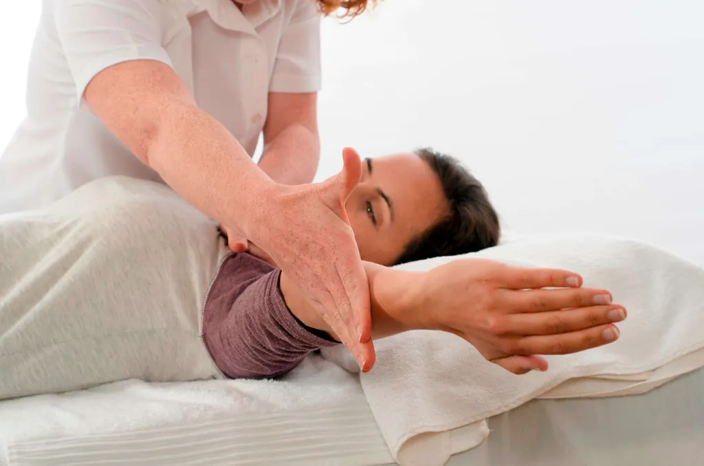 Frau bekommt eine Kinesiologie-Behandlung von einer Therapeutin