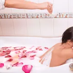 Frau liegt in Badewann und genießt ein Kleopatrabad