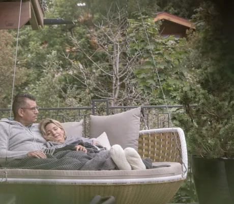 Eine Frau und ein Mann sitzen auf einer Sitzecke im Chalet des Hotel Gassner