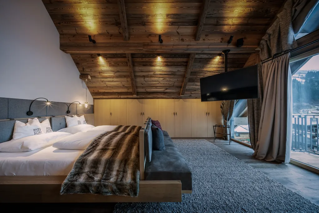 Ein Schlafzimmer im Baumhaus-Chalet des Hotel Gassner