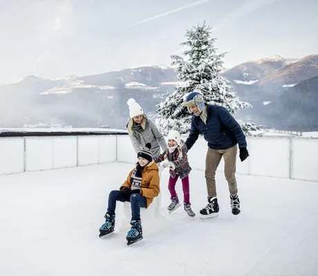 Familie beim Schlittschuhlaufen im Falkensteiner Family Resort Lido