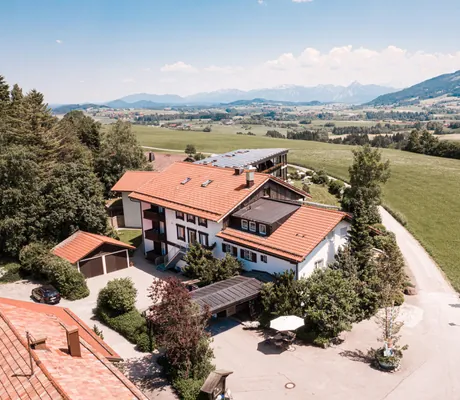 Blick auf das Wellnesshotel Mittelburg, im Hintergrund die Alpen