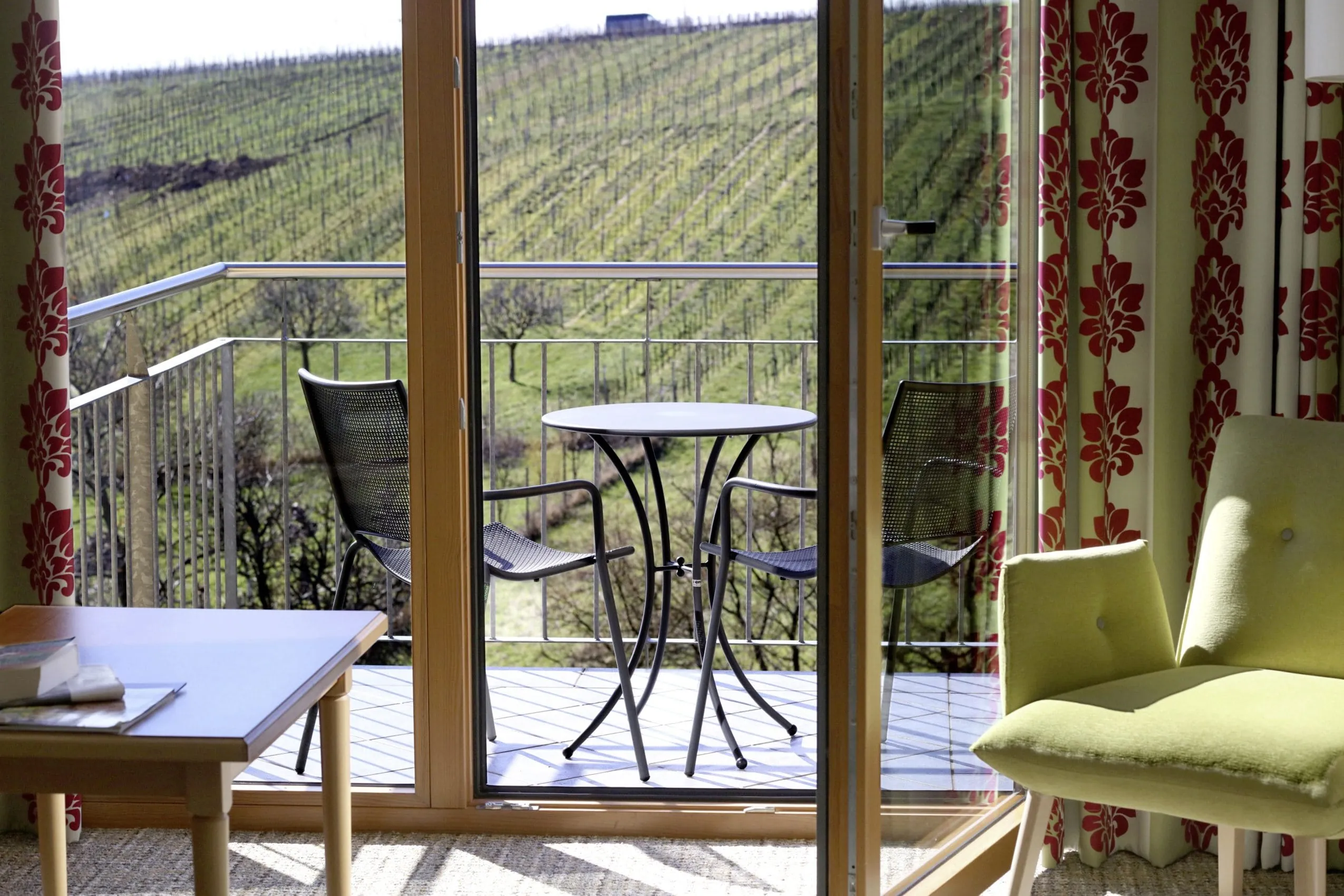 Doppelzimmer mit Balkon im Wohlf&uuml;hlhotel Alte Rebschule und Blick auf die umgenden Weinberge