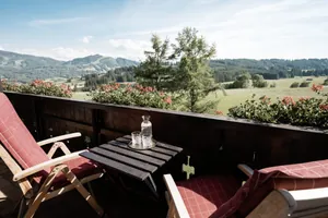 Balkon mit zwei Polsterstühlen im Mittelburg Wellnesshotel und Panoramablick in die umgebende Landschaft