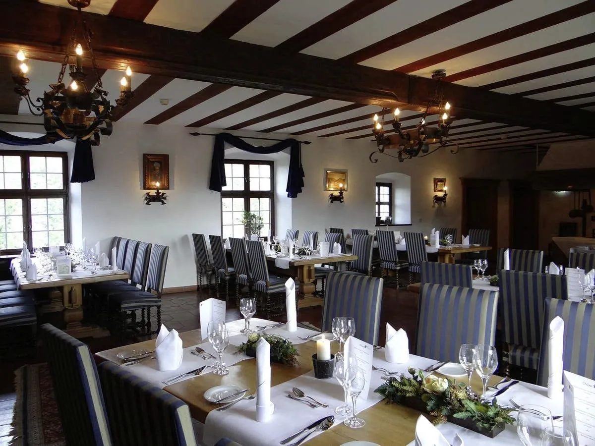 Restaurant mit gedeckten Tischen im Tagungshotel Burg Rabenstein