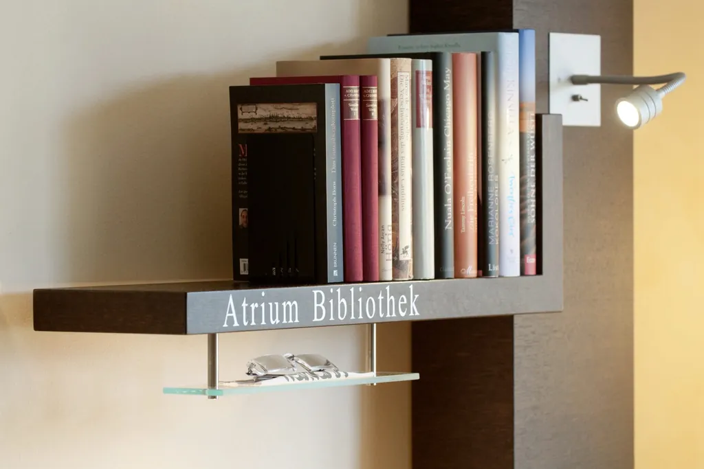 Atrium Bibliothek mit B&uuml;chern, Leseleuchte und Lesebrille im AtriumHotel-Mainz