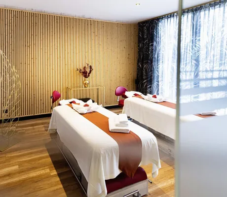 Raum für Paarmassage mit holzvertäfelter Wand im Hotel Bei Schumann