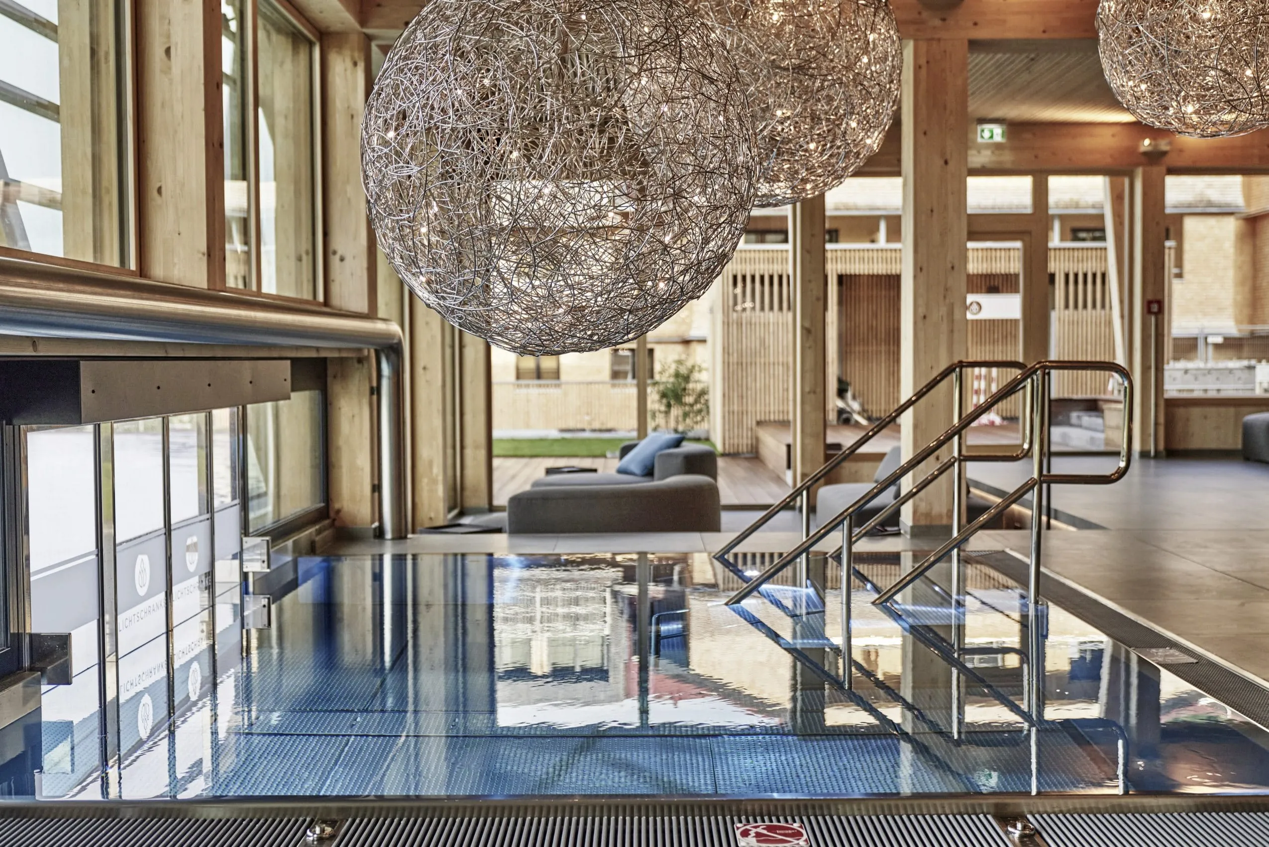 Hochwertig gestalteter Spabereich im HUBERTUS Moutain Refugio Allg&auml;u mit Ausgang zum Outdoorpool