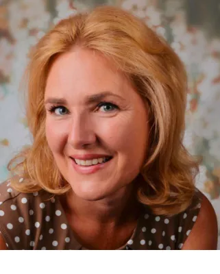 Autorenporträt Susanne Dereser lächelnd mit gepunktetem Oberteil