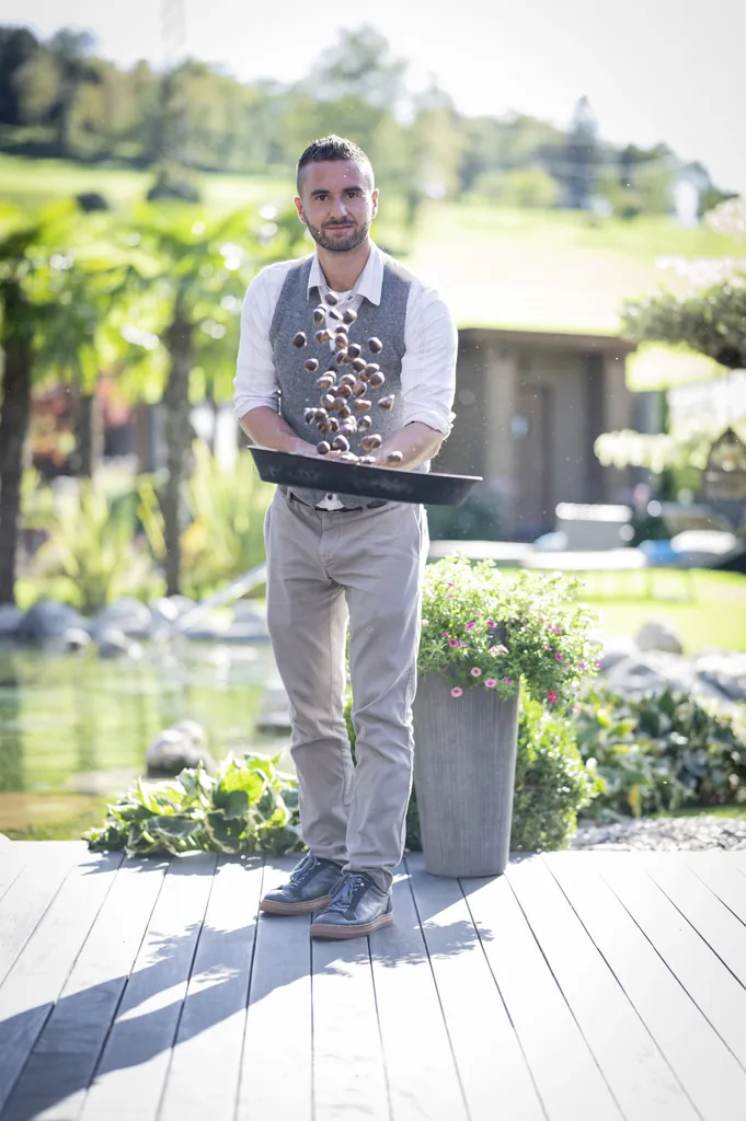 Gastgeber Michael Fink röstet in einer gusseisernen Pfanne die Kastanien fürs Törggelen