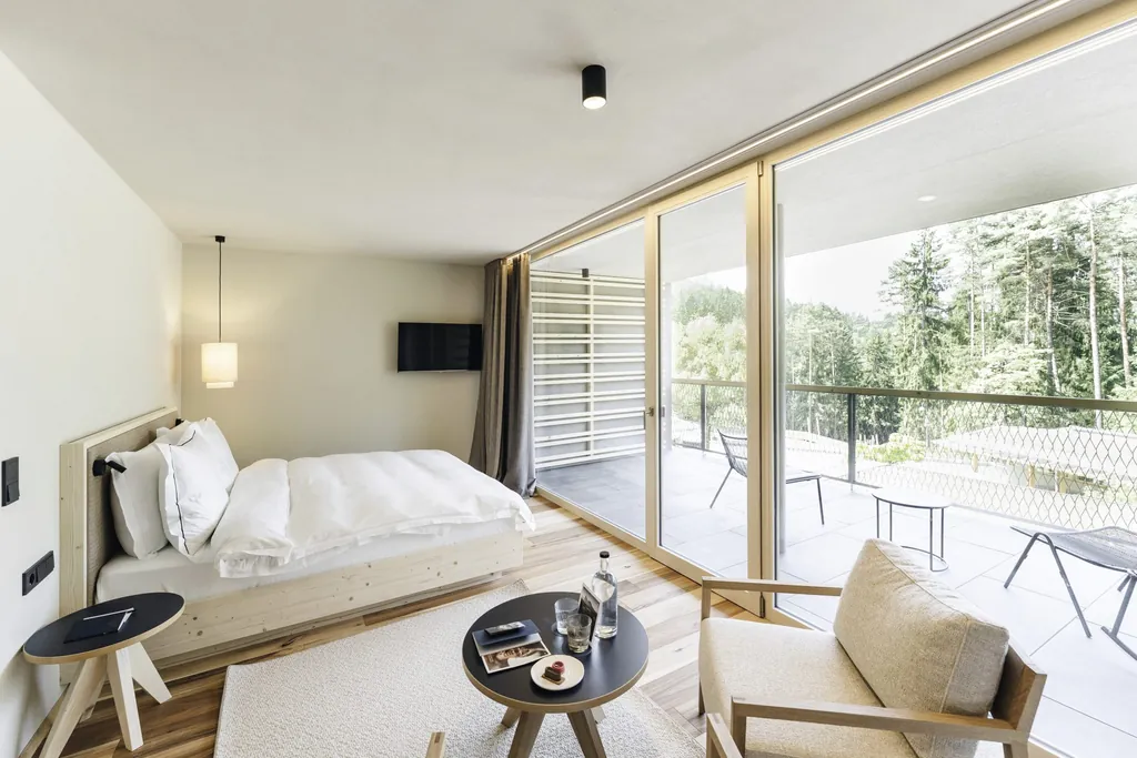 Doppelzimmer mit hellem Holz und beigen Naturmaterialien im Sensoria Dolomites