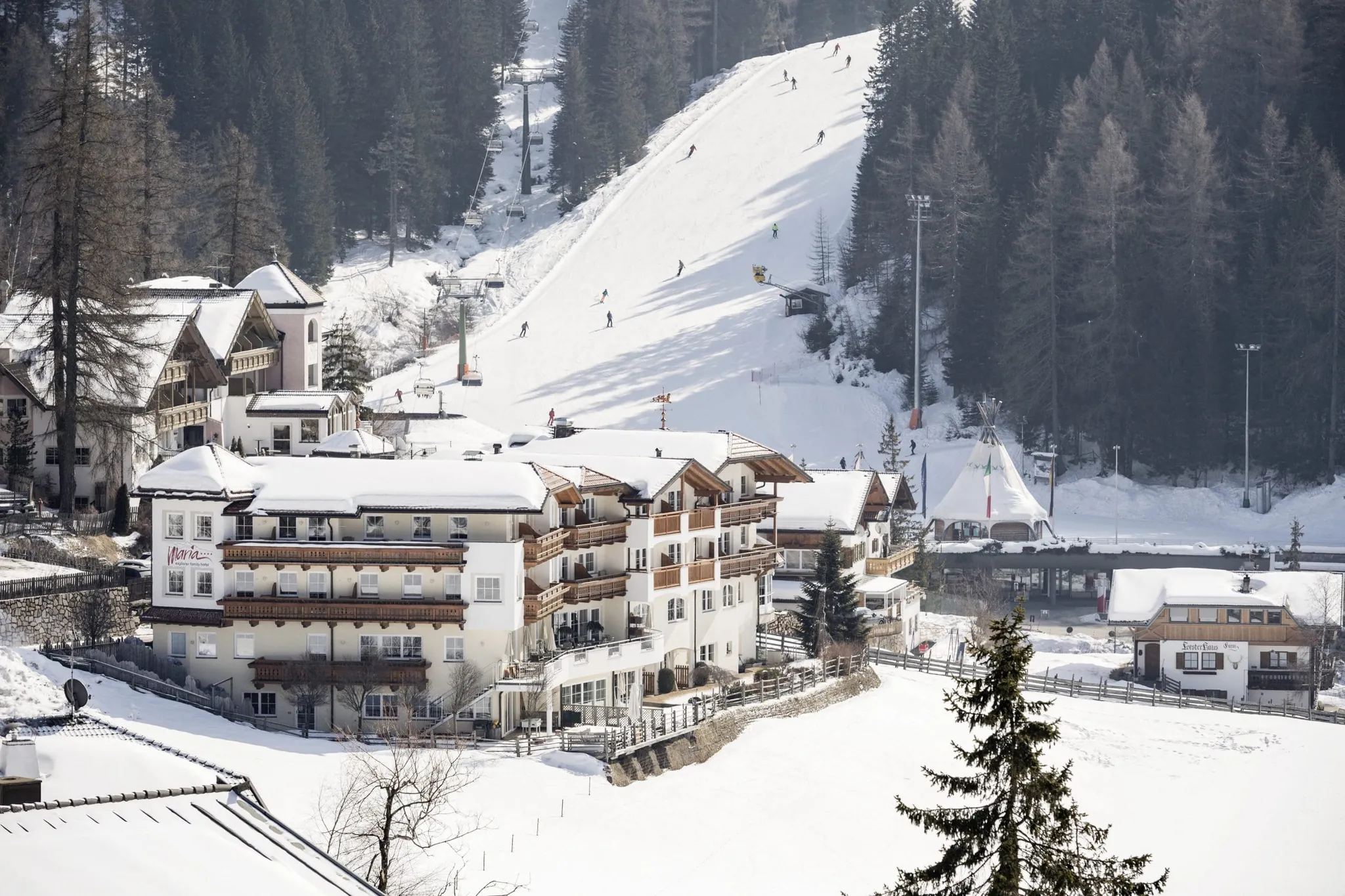Family Adventure Hotel Maria in Schneelandschaft vor Piste mit Skilift