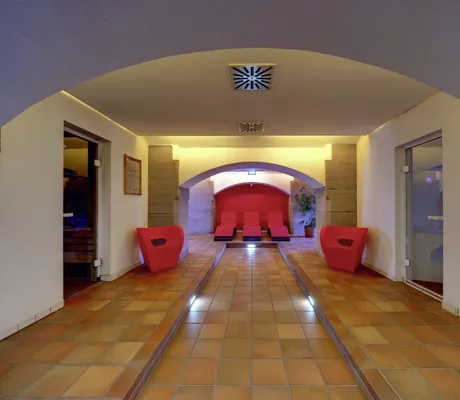 Gewölbeeingang zum Wellnessbereich im nestor Ludwigsburg mit orangen Sesseln