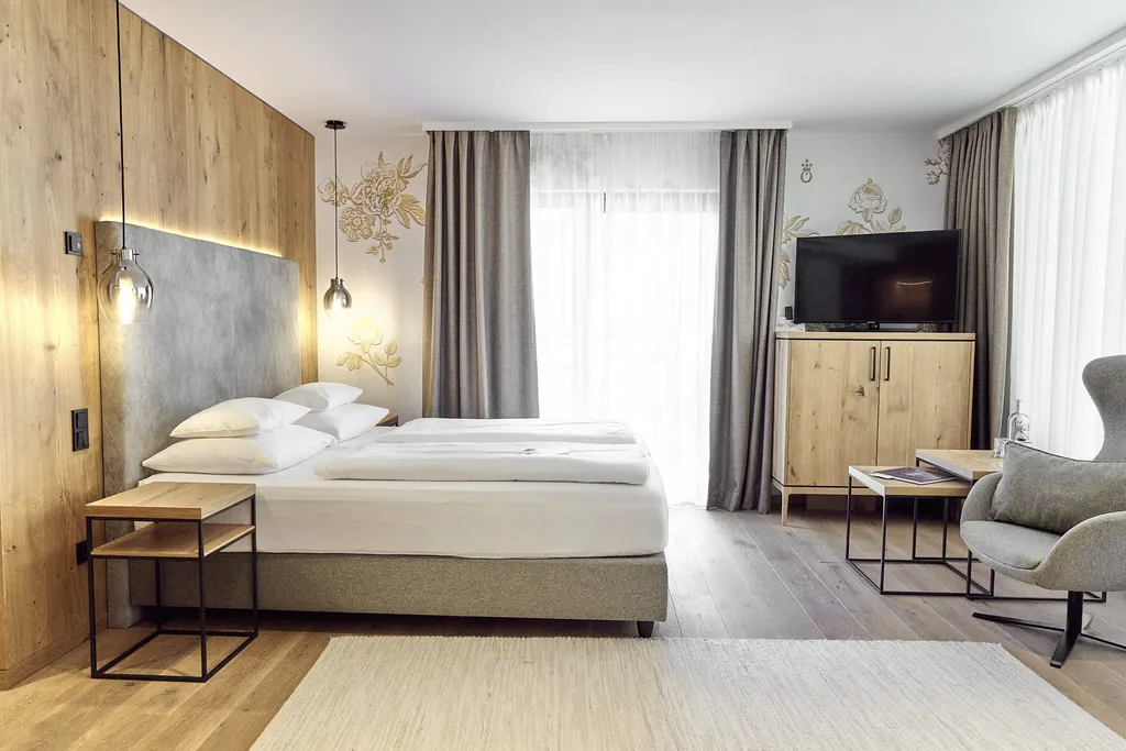 Zimmer im Hotel die HOCHKÖNIGIN mit grauem Ohrensessel