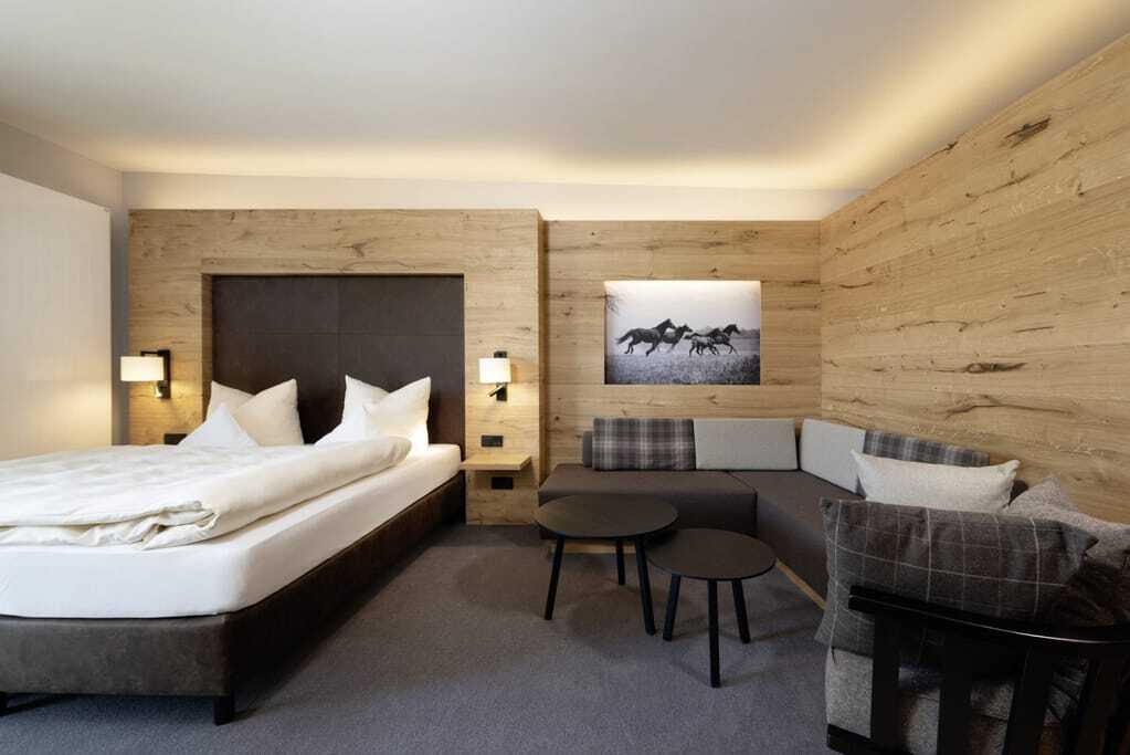 Zimmer im Familotel Schreinerhof mit Holzwänden und Pferdebild an der Wand