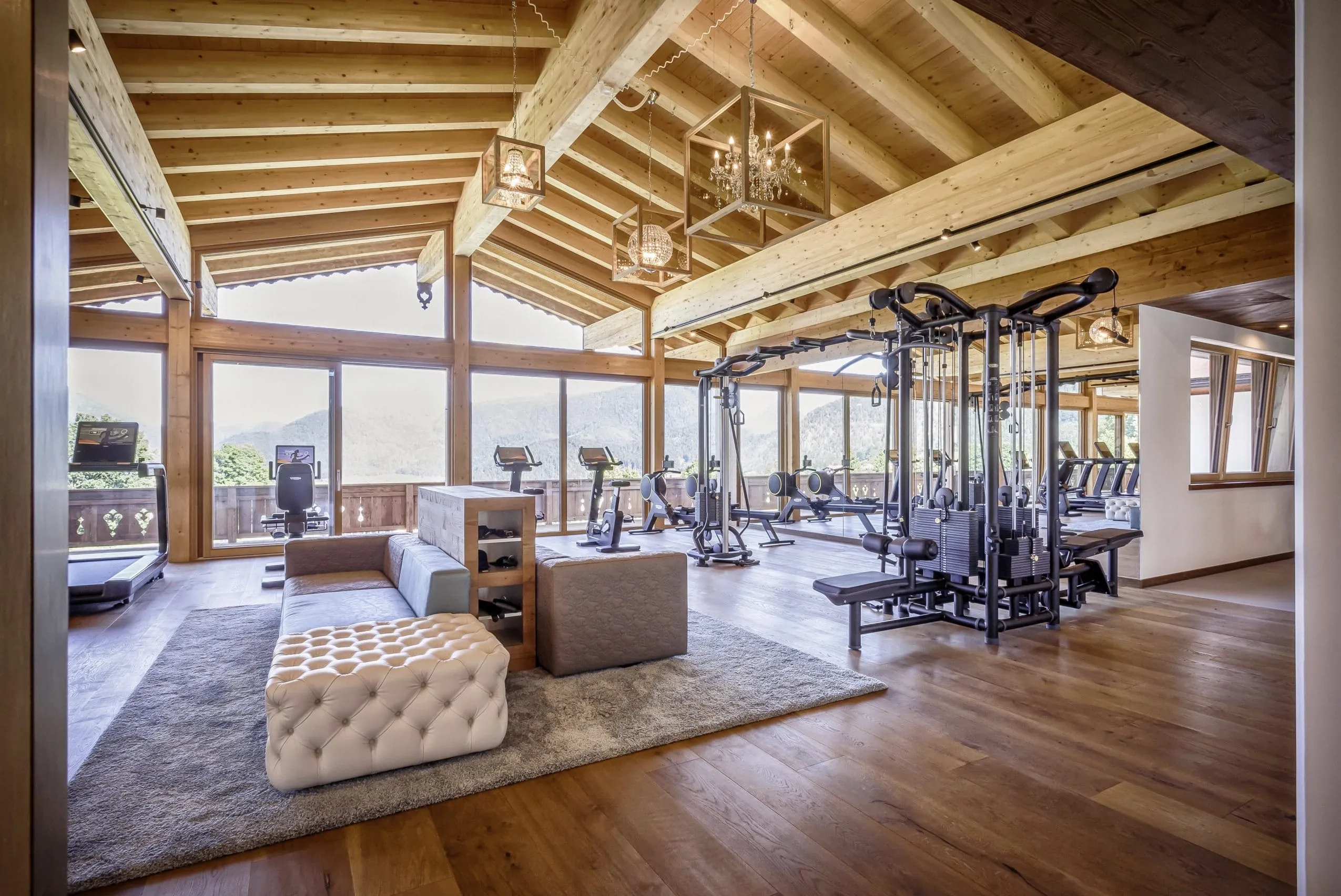 Maisonette-Fitnessstudio mit Sofa und Panoramabalkon im Peternhof Wohlfuehlresort