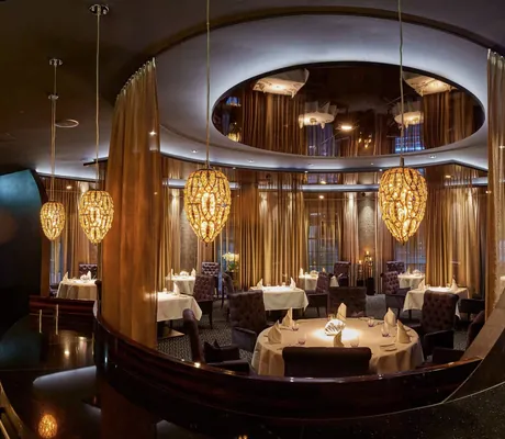 Sternerestaurant Ammolite mit gedeckten Tischen und zapfenförmigen Lampen im Erlebnishotel Bell Rock