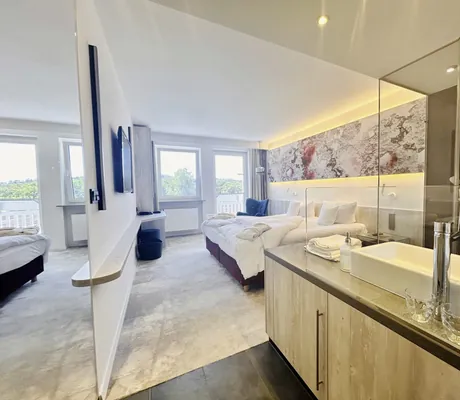 Doppelzimmer im Die Wutzschleife mit Blick vom Badezimmer auf das Bett mit Wassertapete