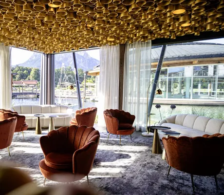 Spa-Relax-Raum Goldstück im Das König Ludwig Inspiration SPA mit goldenen Röhren an der Decke und Sesseln in Muschelform