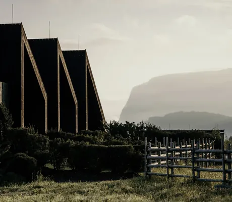 dreieckige Giebel der Eco Lofts im Hotel Pfösl vor dennebenverhangenen Dolomiten