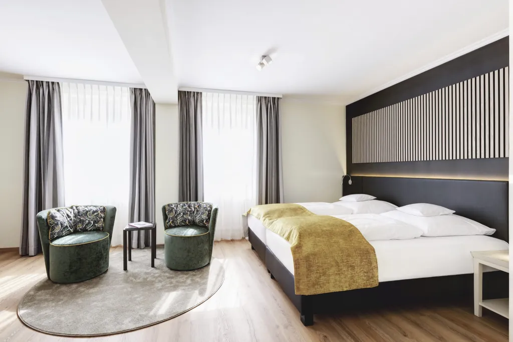 Doppelzimmer im Best Western Hotel Rebstock mit schwarzem Bett mit gelbem Bettüberwurf