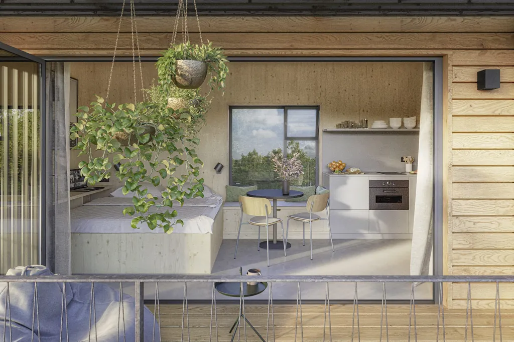 Blick in die Lodge des Ostsee Baumhaushotels mit Bett und kleiner Küche