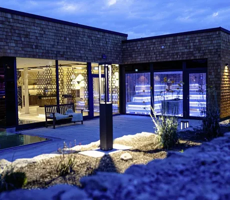 Saunakuben im Das König Ludwig Inspiration SPA von außen mit Blick in Eventsauna und Ruhebereich bei Nacht