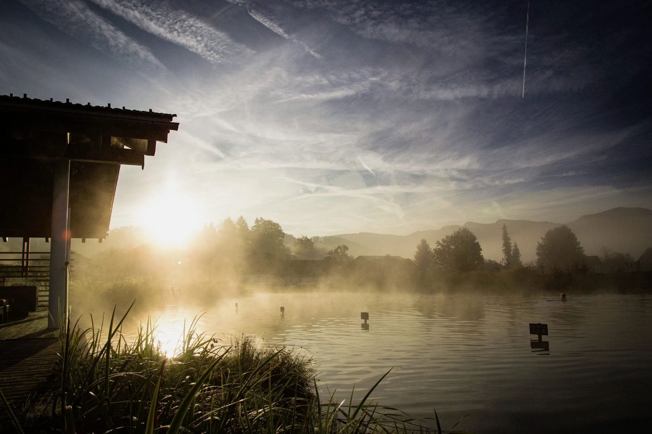 Sonnenuntergang am Natursee mit H&uuml;tte in Haubers Naturresort