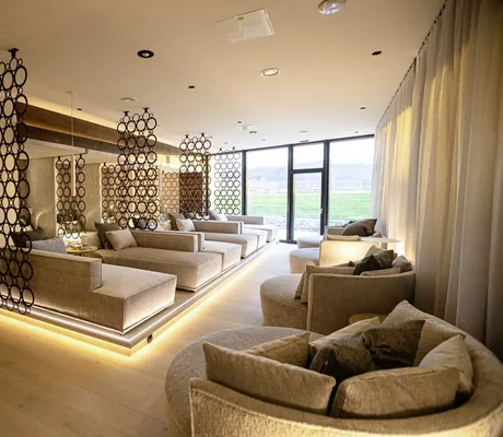 Modern gestalteter Ruheraum mit stimmungsvoller Beleuchtung, runde sowie eckige Relaxliegen