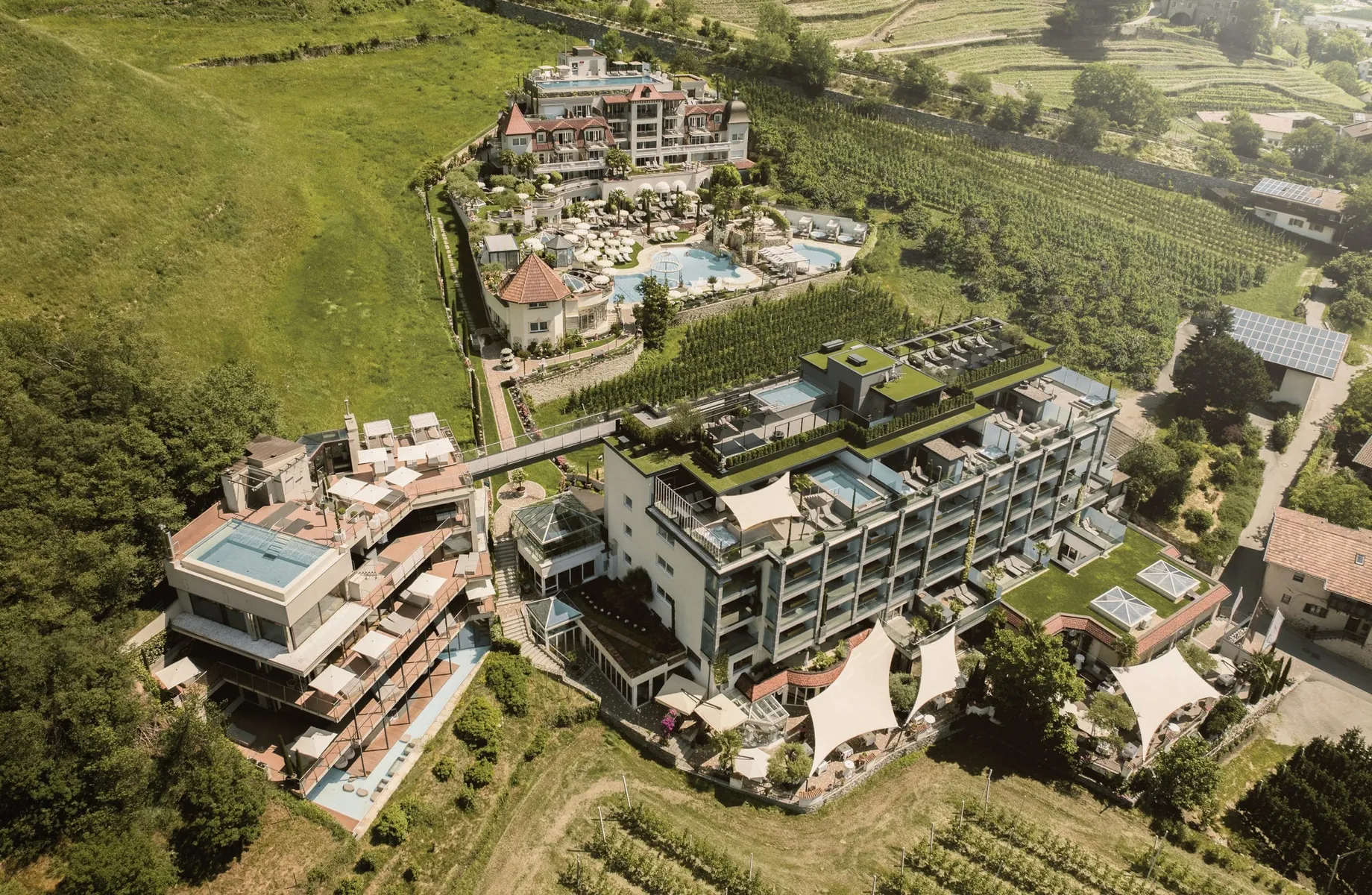 Gesamtansicht des Preidlhof von oben mit Pools und Sonnensegeln