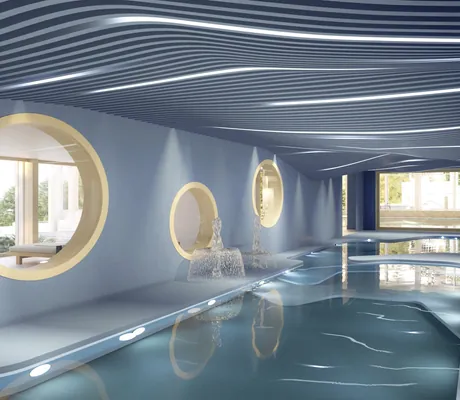 Indoorpool im Suvretta House mit wellenförmigem Dach und runden Fenstern