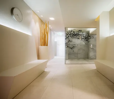 Saunabereich im Wellnesshotel Der Sonnenhof in heller Farbe mit Dusche und Sitzbänken