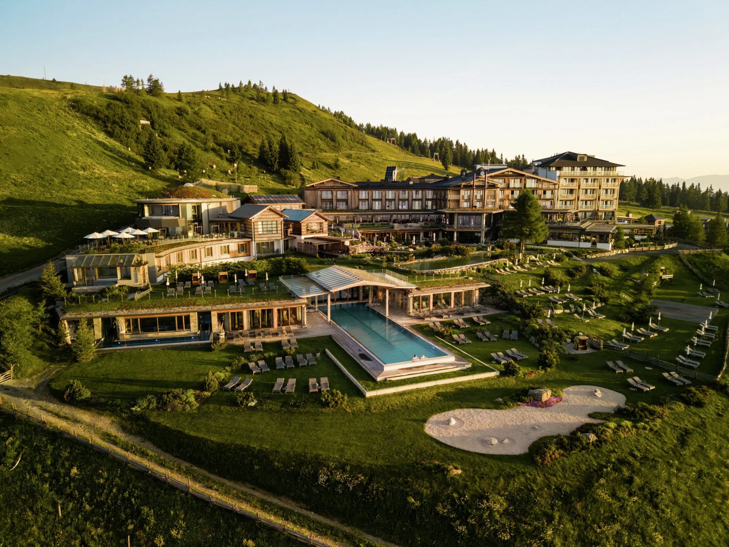 Gesamtansicht Mountain Resort Feuerberg mit großer Gartenanlage und Infinitypool