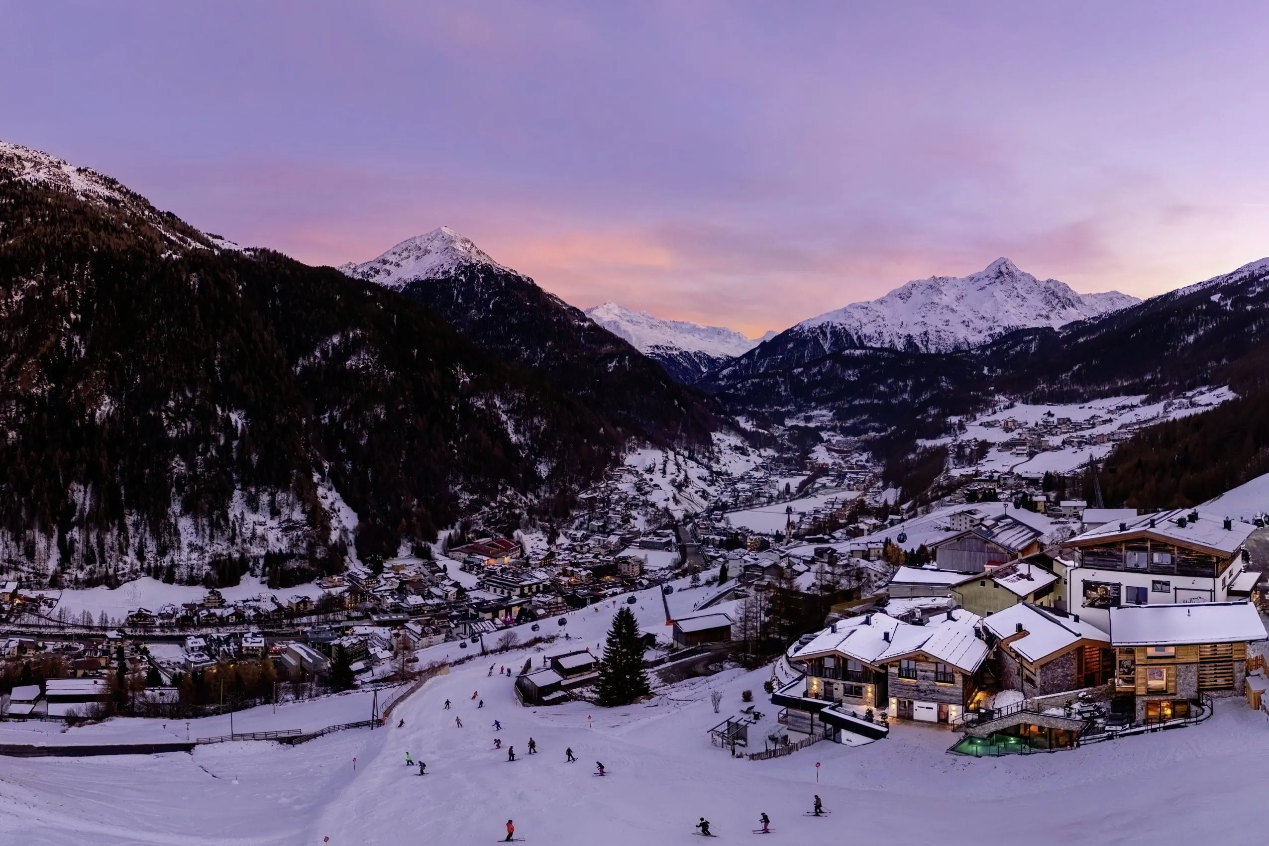 Drohnenansicht des The Peak Sölden mit rotem Abendhimmel und Blick auf den Wellnessbereich mit Pool
