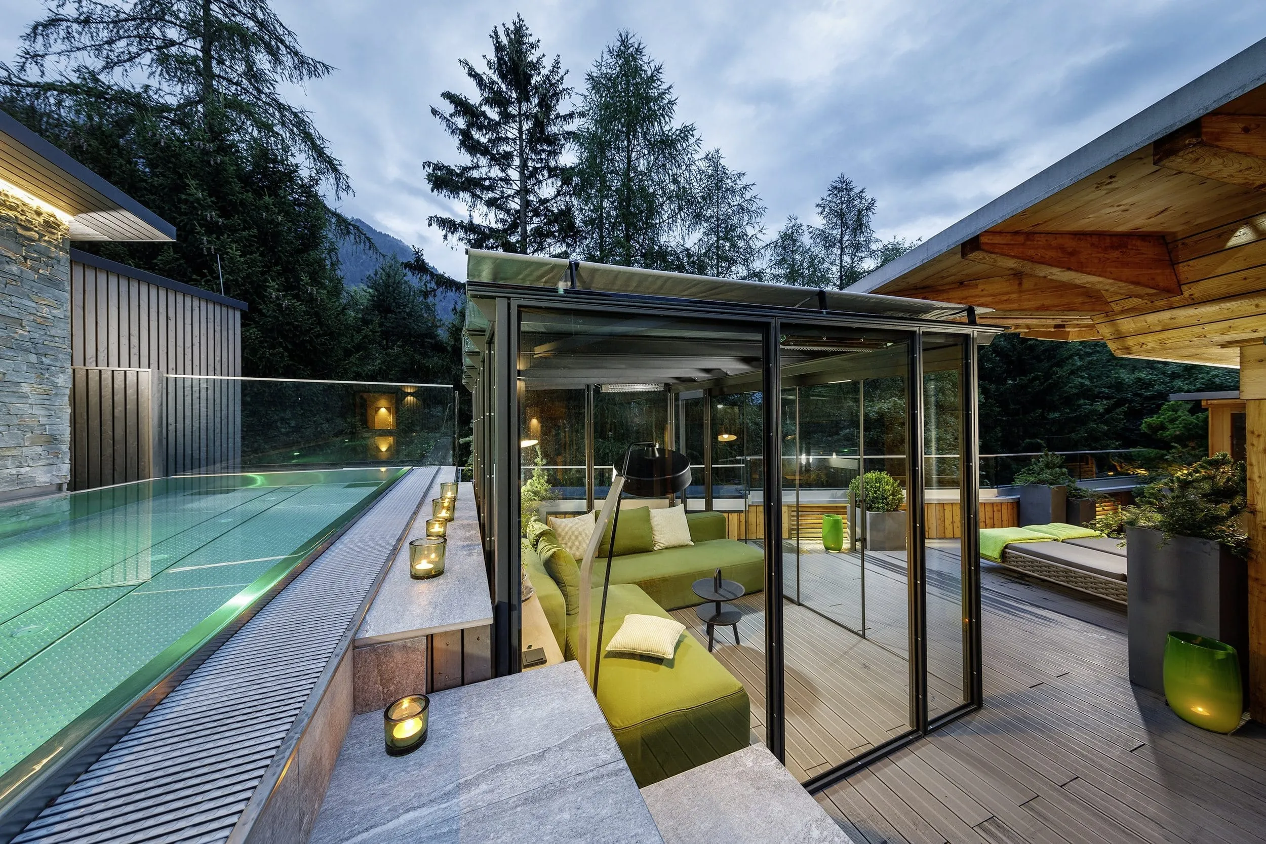 Au&szlig;enpool mit Lounge am Abend im Naturhotel Waldklause