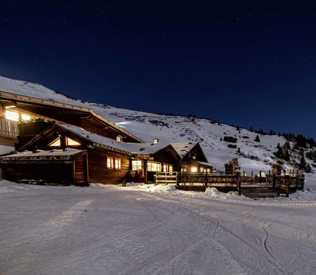 Blick auf das verschneite Chalet Stern bei Nacht