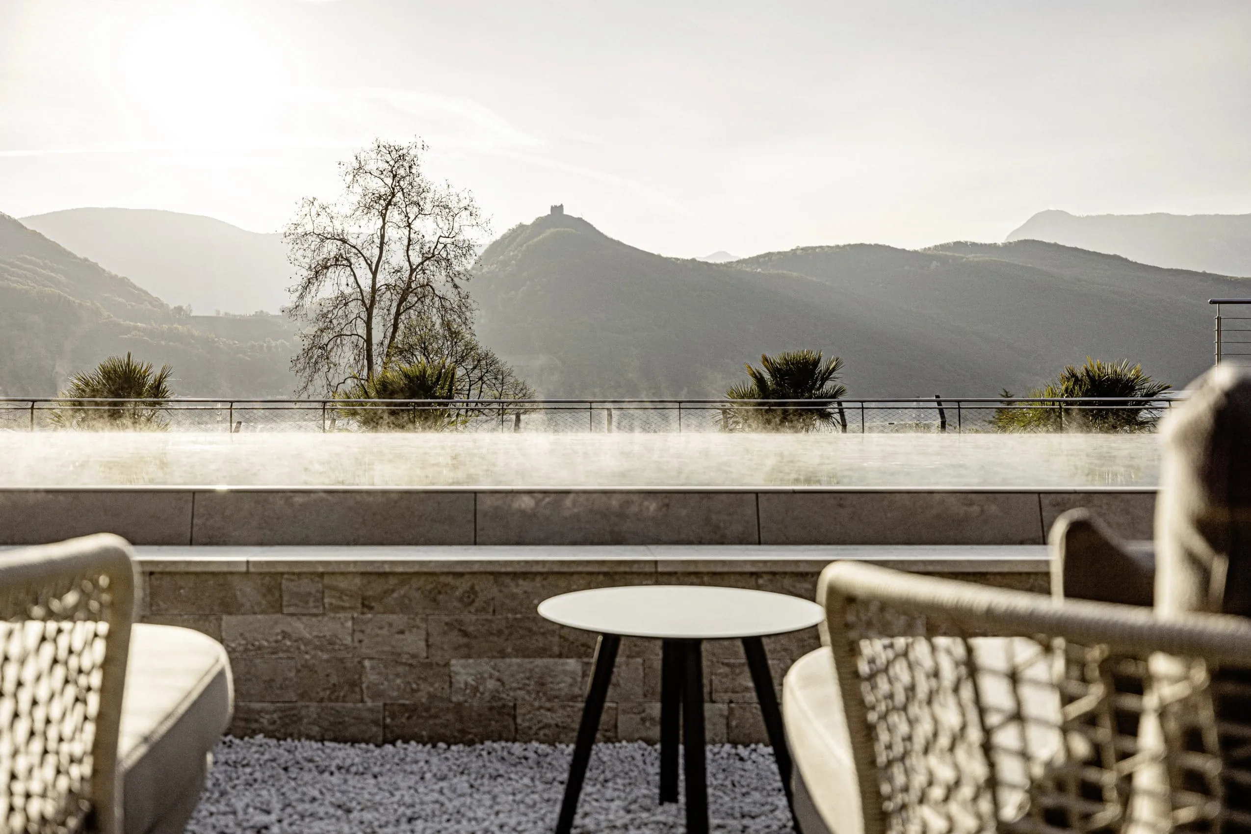Der Infinitypool mit Blick auf Berge und grüne Hügel im SEELEITEN Lake Spa Hotel.
