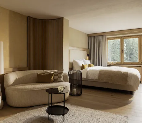 Suite in der Schlossanger Alp mit beiger Sitzecke und Blick in den Wald