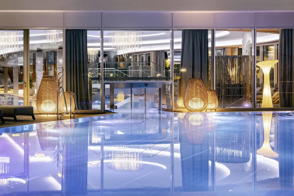Indoorpool im Wellness- und Sporthotel Jagdhof in R&ouml;hrnbach mit Schleuse und gro&szlig;en Designerlampen.