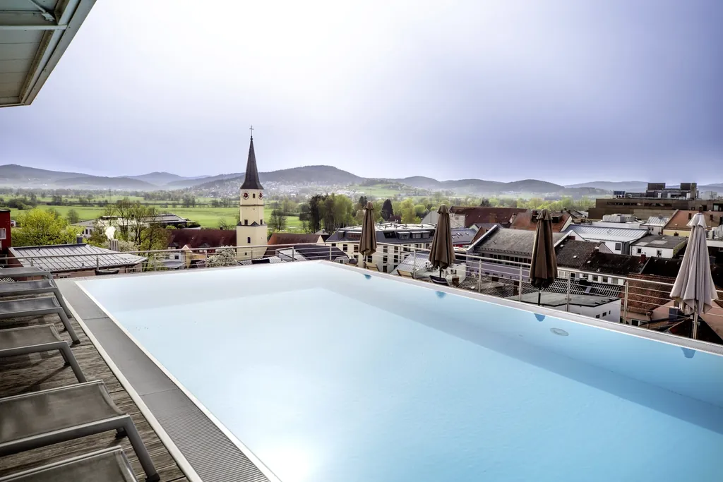 Der Blick vom Skypool im Wellnesshotel Randsbergerhof mit Blick &uuml;ber die roten D&auml;cher Chams und den Bayerischen Wald.