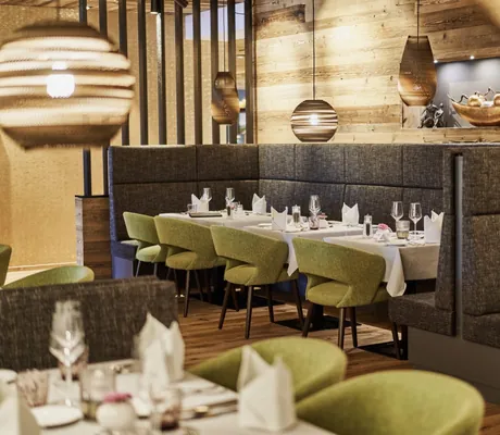 Restaurant im Wellnesshotel Zum Bräu mit grünen Polstersesseln und goldener Dekoschale